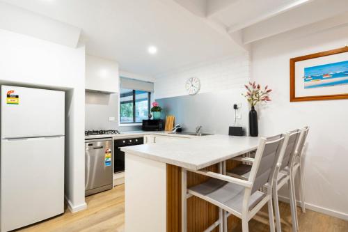 a kitchen with a white counter and a refrigerator at The River Nook on Hurst in Ocean Grove
