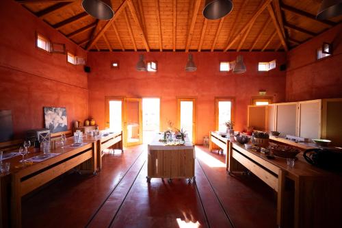 a large room with long tables in a building at eumelia organic agrotourism farm in Goúvai