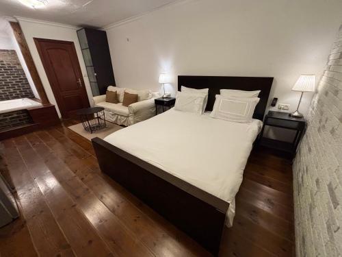 a bedroom with a large bed and a living room at Kesem Bagolan in Had Nes