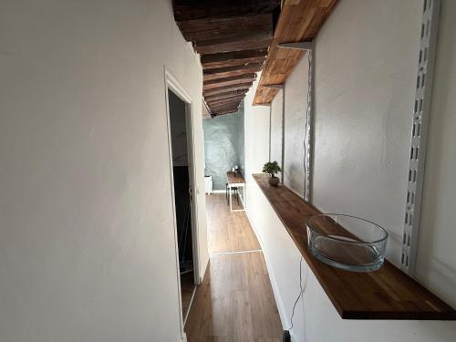 a hallway with white walls and a chair in a room at Chez Eric Studio au coeur de Châtelet in Paris