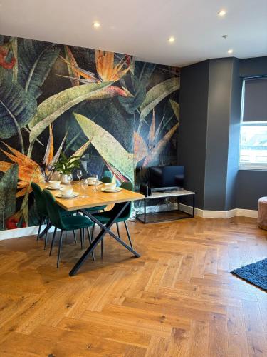 a dining room with a table and chairs and a mural at Cosy flat with sea View in Brighton & Hove