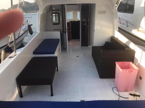 a boat with two benches and a table and chairs at 1 Day Fast boat trip Komodo By Bestkomodotour in Pulau Kukusan