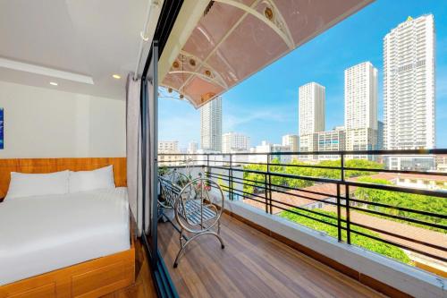 a bedroom with a bed and a balcony with a view at Hằng Nga Hotel in Nha Trang