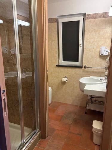 a bathroom with a shower and a sink and a toilet at Locanda Ca Da Iride in Riomaggiore