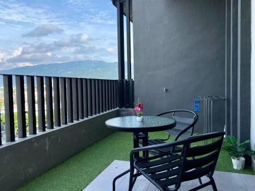 a table and chairs on a balcony with a view at Beacon Executive Suite by stayCATion Homestay in George Town