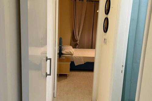 a door leading to a bedroom with a bed at 113 Apartment, A 2-Bedroom Escape in Paphos City