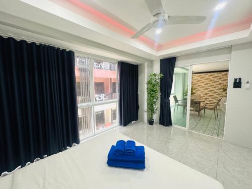 two blue shoes sitting on a table in a living room at Patong best location Apartments, 2 bedrooms in Patong Beach