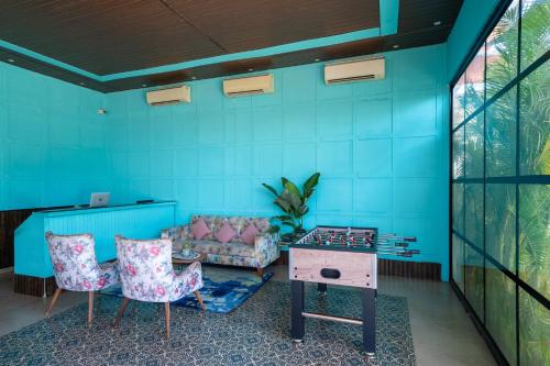 a room with a couch and a table and chairs at Perfectstayz Koko Maya 5 mins walk to beach in Morjim