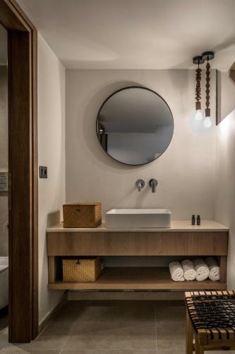 a bathroom with a sink and a mirror at Dream Village in Hersonissos