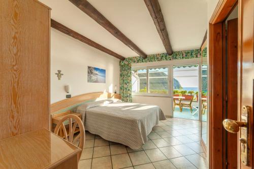 a bedroom with a bed in a room with a patio at Appartamenti Casa del Sole in Ischia