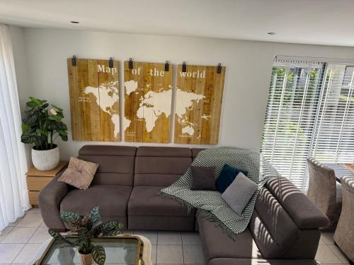 a living room with a couch and a map on the wall at Casa Bep in Zevenhuizen