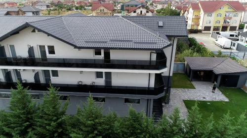 an aerial view of a white house with a black roof at Grey Residence in Drobeta-Turnu Severin