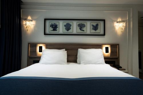 a bedroom with a large white bed with two pillows at Mona Bosphorus in Istanbul