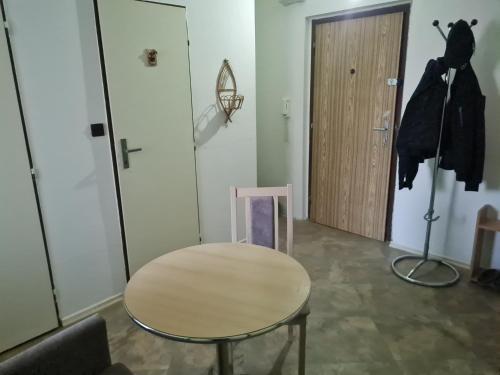 a table and a chair in a room with a door at Modern urban loft apartment in Opava