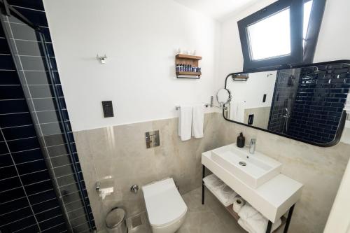 a bathroom with a sink and a toilet and a mirror at Mona Bosphorus in Istanbul