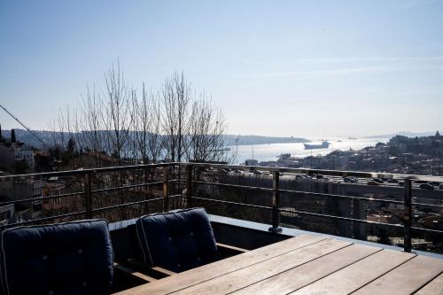 a wooden table with two chairs on top of a balcony at Mona Bosphorus in Istanbul