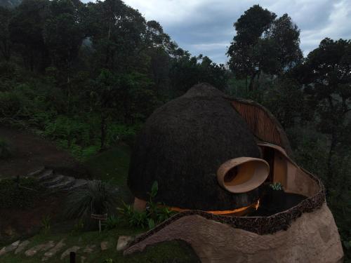 a small house with a fire in a field at Toroland Munnar in Viripara
