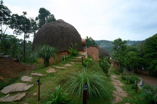 a building with a large dome in a field at Toroland Munnar in Viripara