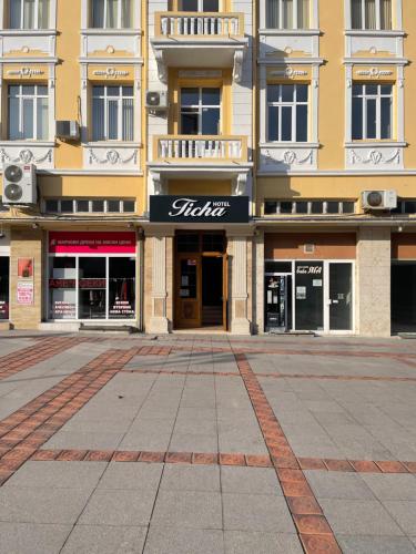 an empty street in front of a building at Hotel Ticha in Shumen