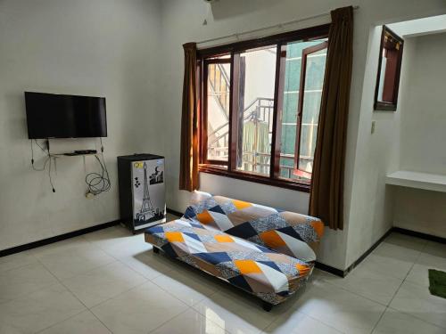 ein Wohnzimmer mit einer Couch und einem Fenster in der Unterkunft Grand Valora 1 in Semarang