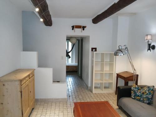 un salon avec un canapé et une table dans l'établissement Maison de ville historique dans la Haute Ville -, à Vaison-la-Romaine