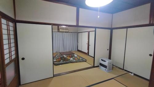 an empty room with a tv on the floor at 一棟貸しおおふなと長月 Vacation Rental Ofunato-Nagatsuki in Gero