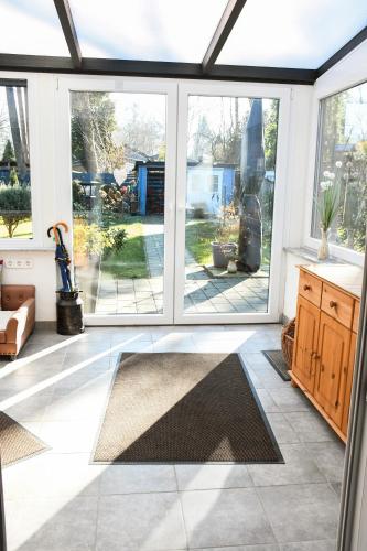a conservatory with sliding glass doors in a house at Ferienhaus Zissi in Wegberg