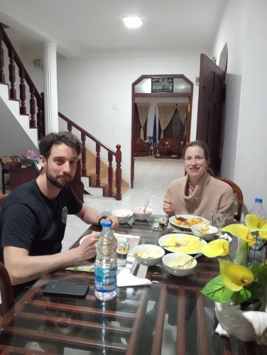 a man and woman sitting at a table with food at Power Zone Guest House in Matale