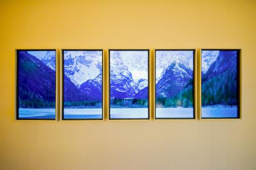 a row of four windows with snow covered mountains at Yoichi Nap in Yoichi