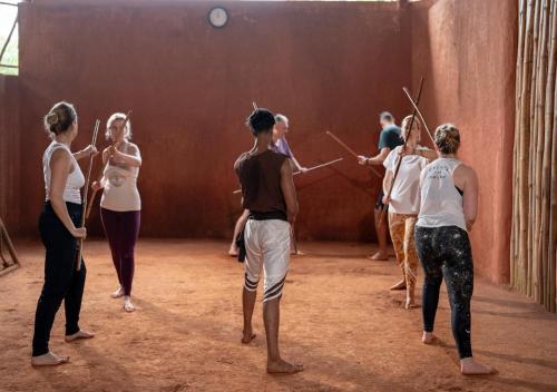 a group of people standing in a dance class at Jeevess Retreat Wayanad in Wayanad