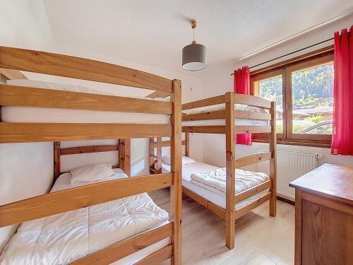 deux lits superposés dans une chambre avec fenêtre dans l'établissement Etoile Filante 1, à Morzine