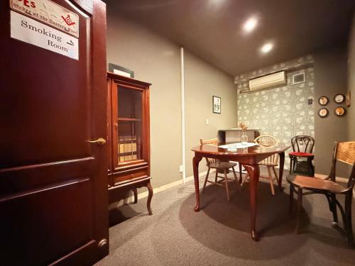 a room with a table and a table and chairs at Hotel Gasthof in Kagoshima