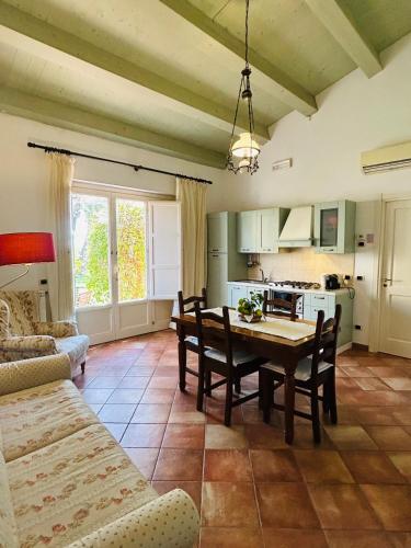 a kitchen and dining room with a table and chairs at Torre Archirafi Resort in Riposto