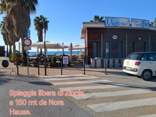 a white van parked in front of a restaurant at NORA House in Savona