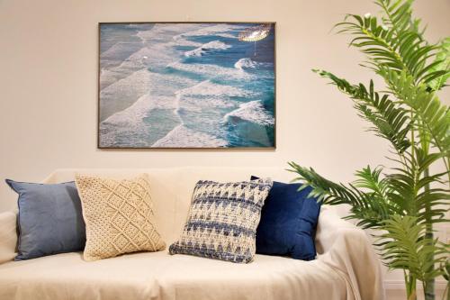 a living room with a couch with a picture on the wall at Li Kotohogi 4F,5F in Naha