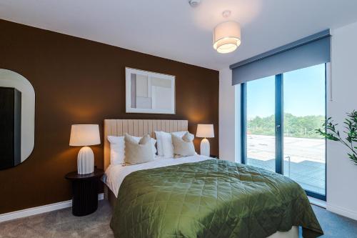 a bedroom with a large bed and a large window at Leeds City Centre - HIGH SPEC!! Stunning 2 Bedroom Apartment BRAND NEW!! in Beeston Hill