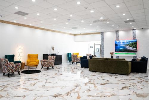 a lobby with couches and chairs and a flat screen tv at Super 8 by Wyndham Corpus Christi Airport in Corpus Christi