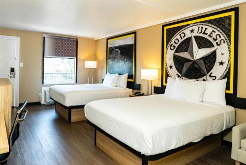 a hotel room with two beds and two lamps at Super 8 by Wyndham Corpus Christi Airport in Corpus Christi