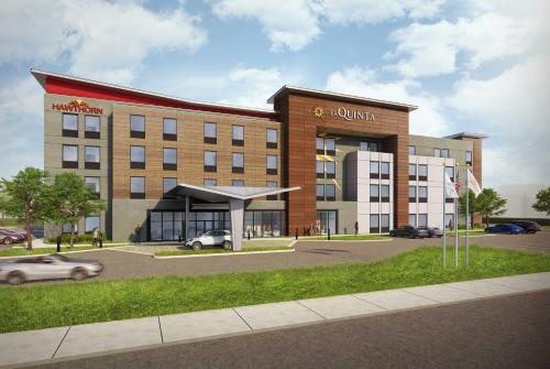 a rendering of a building with a car parked in front at Hawthorn Extended Stay by Wyndham Mebane in Mebane