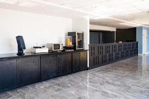 a room with black cabinets and a counter top at Baymont by Wyndham Corpus Christi Airport in Corpus Christi