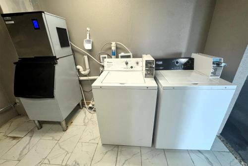 a kitchen with a stove and a refrigerator at Baymont by Wyndham Corpus Christi Airport in Corpus Christi