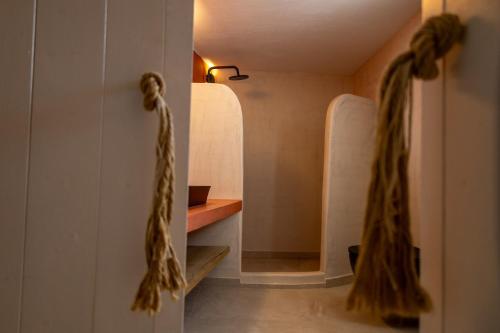 a hallway with two white doors with ropes on them at Christina's Cozy Snuggery in Akrotiri