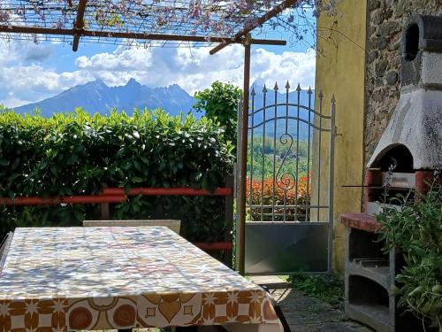 a patio with a table and an open door with a view at Agriturismo Palazzo Vescia in Quercia di Aulla