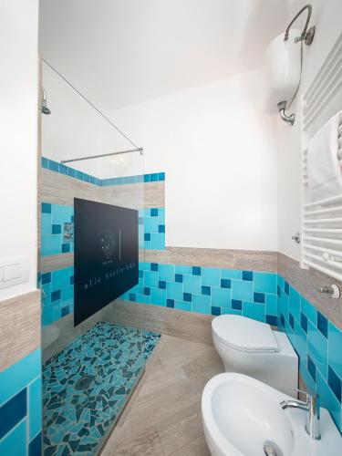 a bathroom with a toilet and a sink and a tv at The Sun by alle Stelle b&b in Anacapri