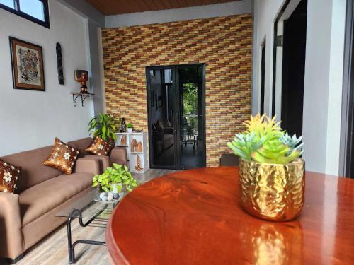 a living room with a couch and a table at Goldland Caelestis Guest House in Bacolod