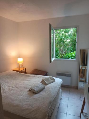 a bedroom with a bed and a window at Bright T2 Workspace & WiFi Fiber, 5 min to Sophia Antipolis, 10 to Antibes in Mougins