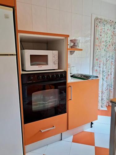 a kitchen with an oven with a microwave in it at Apartamento MILA centro in Comillas