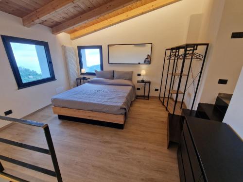 a bedroom with a bed and two windows at Dimore d'Oltremare - Appartamento Libeccio in Lavagna