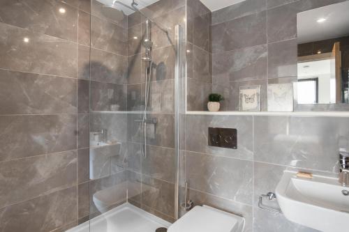 a bathroom with a shower and a toilet and a sink at Luxurious 2 bed city centre apartment!!! in Birmingham