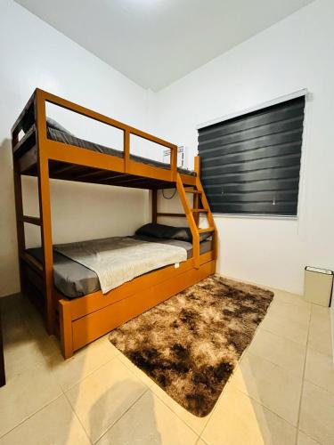 a bedroom with two bunk beds and a rug at Casa Esperanza 1376 in Dauis